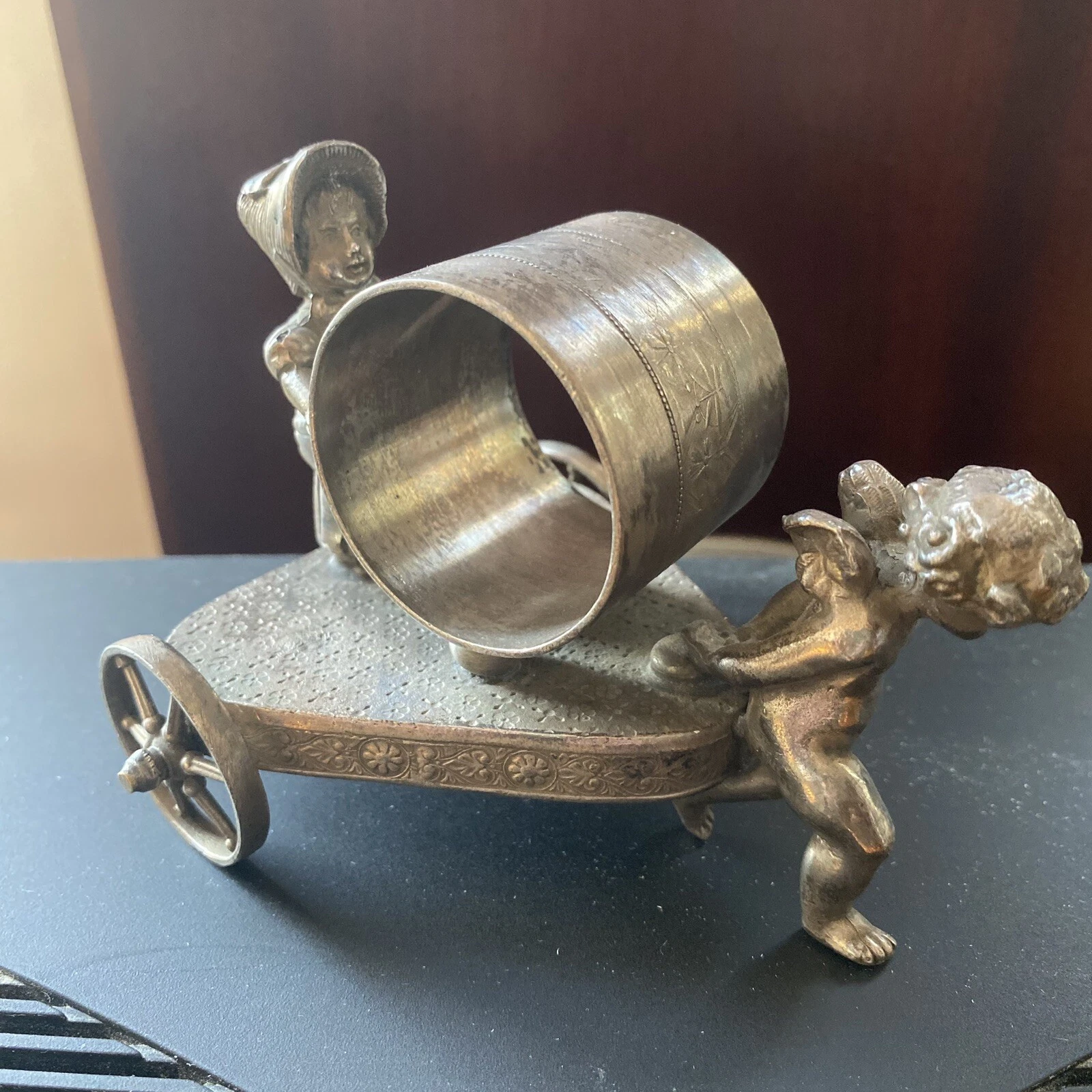 Kate greenaway girl being pulled along by a cherub.