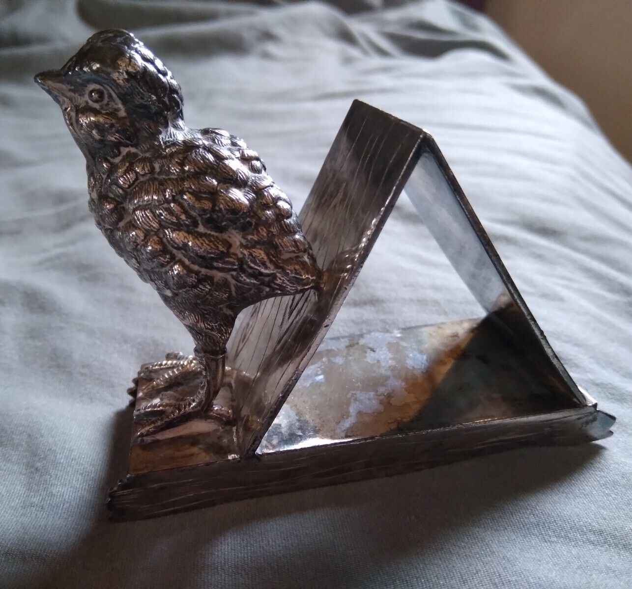 Large chick with triangular shapped ring. The base also looks like a sled. Wilcox 01585