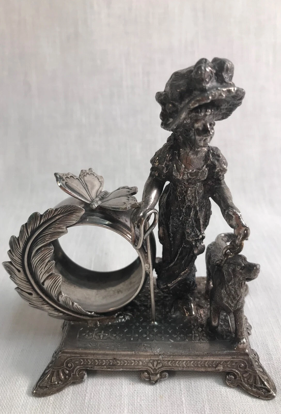 4 FAKE Tufts figural napkin rings. All marked Tufts 1161. Same base.