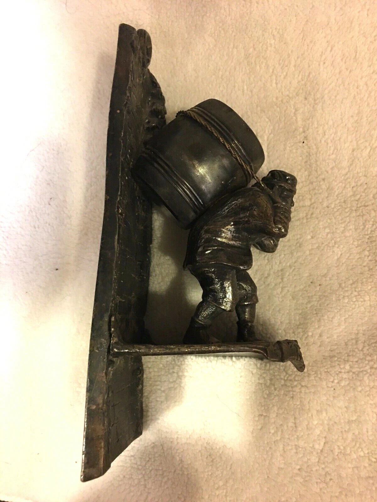 man carrying barrel wall match holder, Tufts 2596