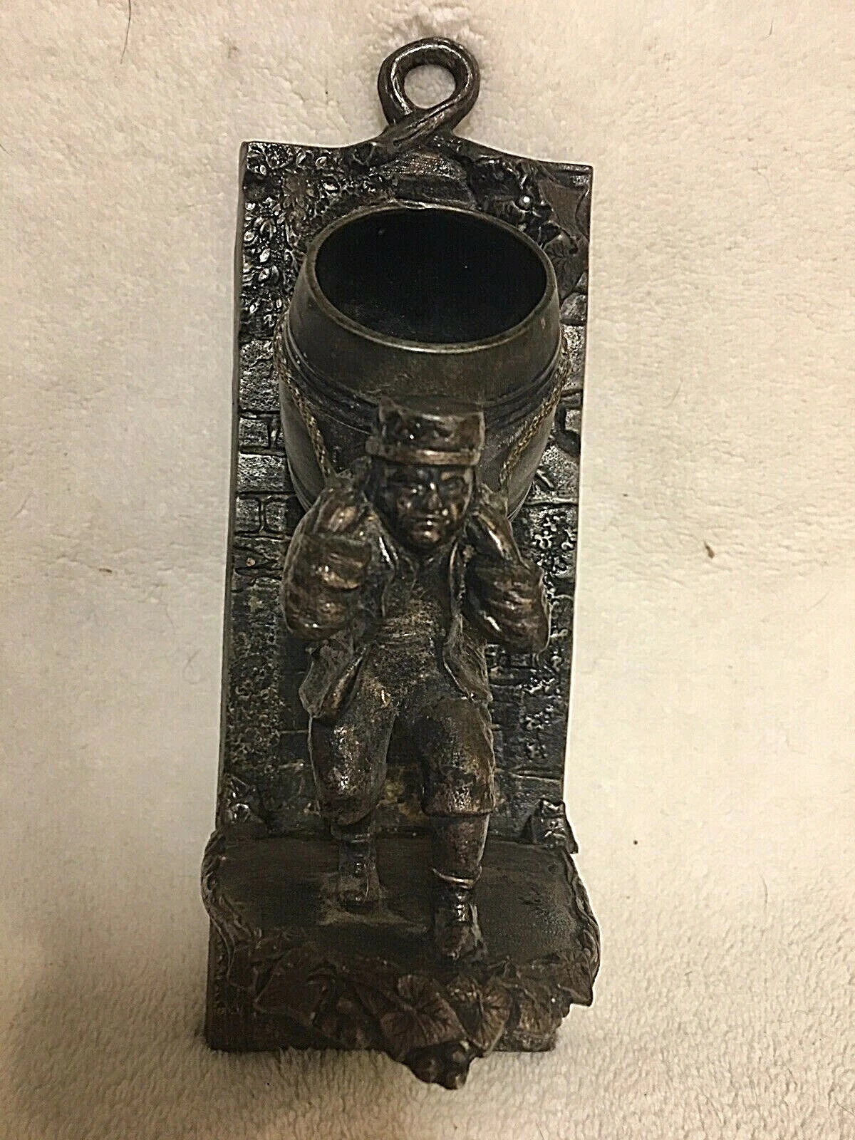 man carrying barrel wall match holder, Tufts 2596